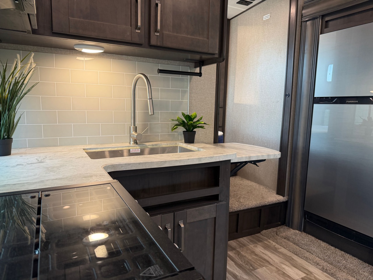 Residential kitchen with stainless sink and subway tile