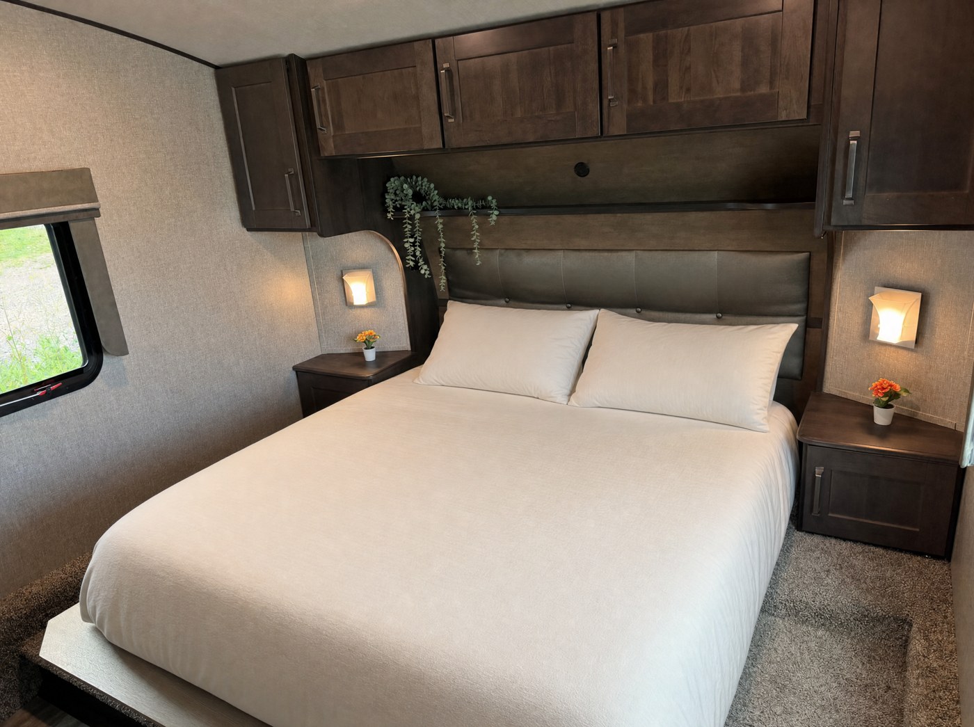 Master bedroom with double bed, nightstands and overhead storage